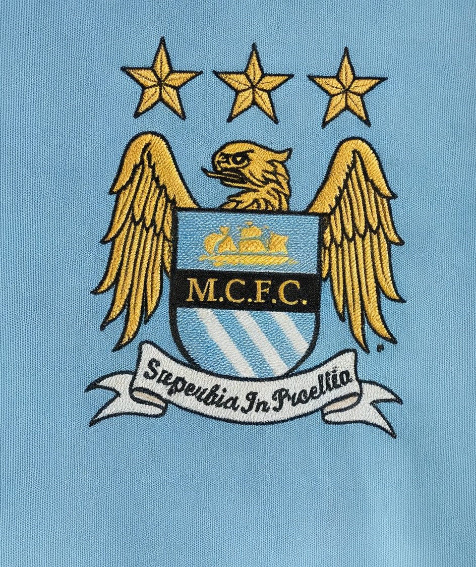 Manchester City 2011/12 home shirt — club crest close-up