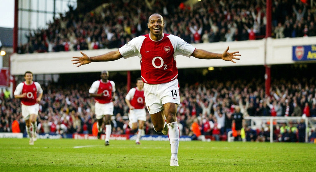 Thierry Henry celebrating a goal in the 2003/04 Arsenal home kit