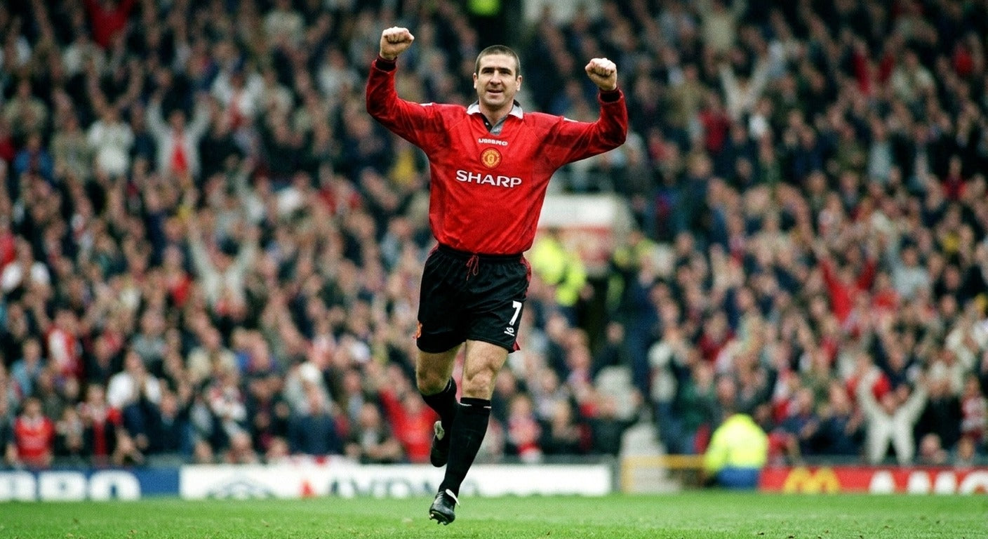 Eric Cantona celebrating in the Manchester United 1996/97 home shirt