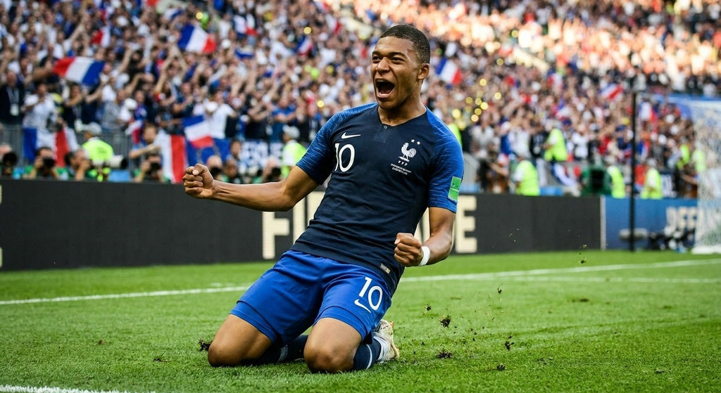 Kylian Mbappe celebrating in the France 2018 home shirt