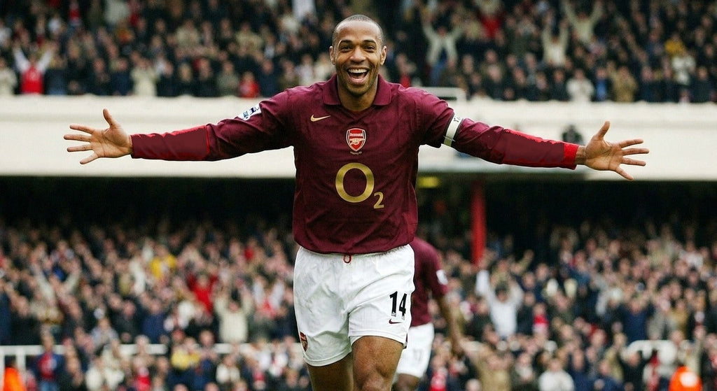 Thierry Henry celebrating in the Arsenal 2005/06 home shirt